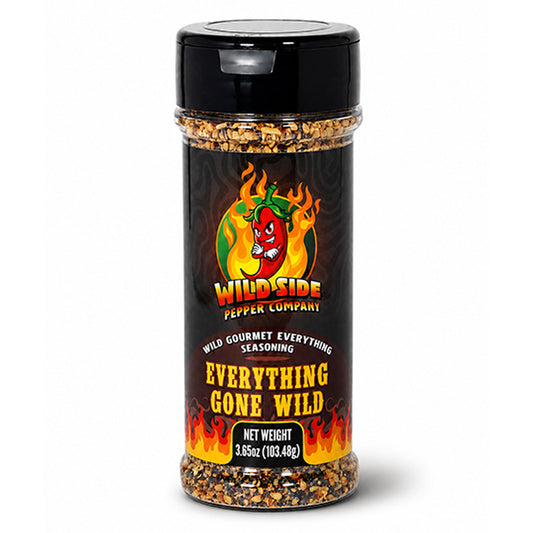 A bottle of Wild Side Pepper Company Everything Gone Wild seasoning, featuring a black cap and a black label with red, yellow, and orange flame graphics and a red chili pepper logo.