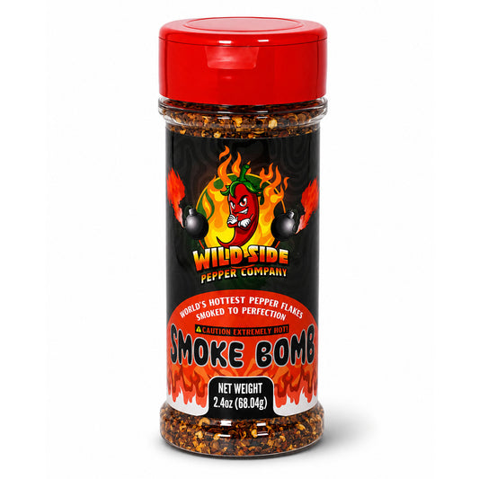 A bottle of Wild Side Pepper Company Smoke Bomb seasoning with a red cap and a black label featuring a red cartoon chili pepper and flames.